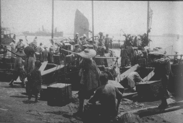 TEA FROM NATIVE DISTRICTS  Picture shows native tea dealers at Ku-kiang bringing in tea for transport to the great tea factories in Hankow, where it is prepared for export.