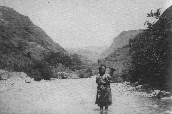 A LONELY TRAVELER  This picture was taken far out in untraveled China Far West. For days you meet no sign of human habitation, and woe betide you if the river rises!