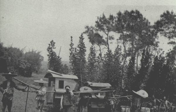 AUTHOR'S CARAVAN ON THE MARCH  On the main road west of Chung-king—the Author's four-man chair engaged to "save his face," and his servant's two-man chair, followed by the coolies.