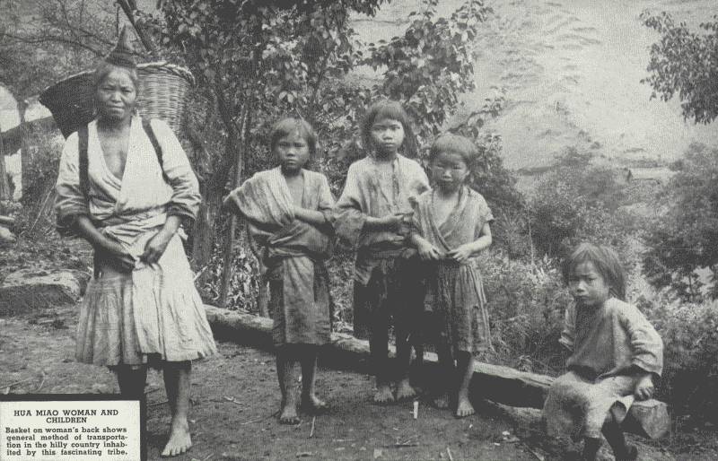 HUA MIAO WOMEN AND CHILDREN  Basket on woman's back shows general method of transportation in the hilly country inhabited by this fascinating tribe.