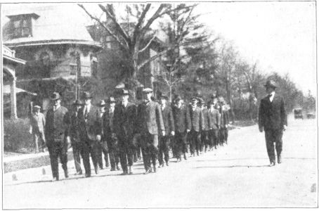 EFFECT OF THIRTY DAYS OF TRAINING UPON A COMPANY. THESE MEN ARE CARRYING IRON BARS WEIGHING NINE POUNDS EACH