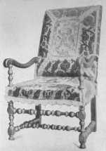 A typical Louis XIII chair, many of which were covered  with velvet or tapestry.