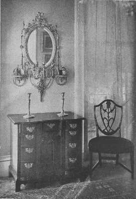 A valuable collection of an Adam mirror, a block-front,  knee-hole chest of drawers, and a Hepplewhite chair.