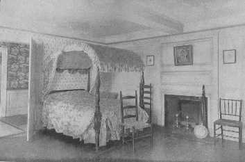 Dorothy Quincy's bedroom contains a fine old mahogany field bed, which is appropriately covered with the flowered chintz popular at the end of the Eighteenth Century. The chairs are fitting for  all bedrooms decorated in Colonial style. Notice the woodwork in the  room and hall.