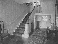 The Oriental rug used on the stairs harmonizes with those used on the floor.