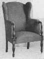 A wing-chair with a painted frame is comfortable and harmonizes with painted furniture.