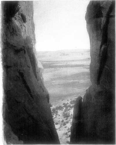 LOOKING THROUGH A CREVICE OF THE ENCHANTED MESA.