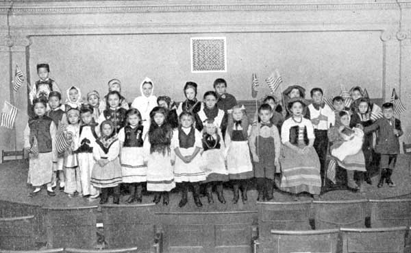 Children of Many Nationalities at Christmas Celebration in a New York School.  Chinese, Italians, Swedes, Irish, English, German, French, Russian, Austrian.