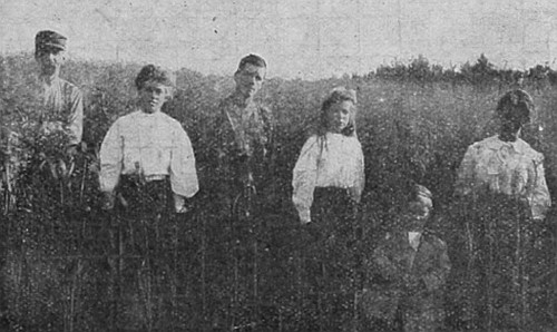 A healthy family from Nebraska, now living in Western Canada. Observe the height of the oats. The crop yielded 70 bushels per acre.