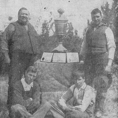 Mr. J. C. Hill & Sons, of Lloydminster, Saskatchewan, who recently became winners for the third time of the Colorado Silver Trophy, valued at $1500 for best peck of oats in the world. They now own the trophy.