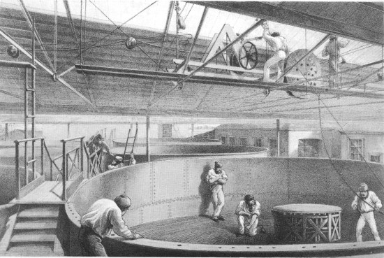 R. M. Bryson, lith from a drawing by R. Dudley  London, Day & Sons, Limited, Lith.  COILING THE CABLE IN THE LARGE TANKS AT THE WORKS AT GREENWICH.