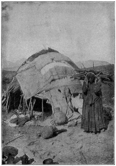 Apache woman carrying wood