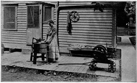 Woman using petrol engine powered washing machine