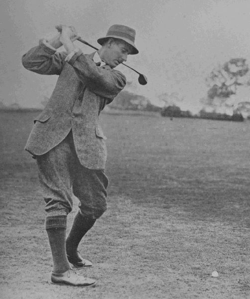 PLATE IV.  HARRY VARDON  At the top of his swing in the drive. This is a fine illustration of Vardon's perfect management of his weight, which is mainly on his left foot. Observe carefully the wrists, which are in the best possible position to develop power.