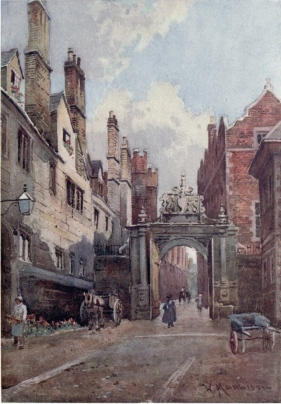 NEVILE’S GATE, TRINITY COLLEGE  To the left are the College kitchens and on the right is Bishop’s Hostel. The buildings on the left are among the most ancient in this college. Through the picturesque old gateway we see up the lane into Trinity Street.