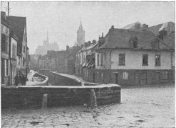 RUE BASSE DES TANNEURS seen from the Rue Condé. In the background, steeple of the Church of St. Germain and the Cathedral.