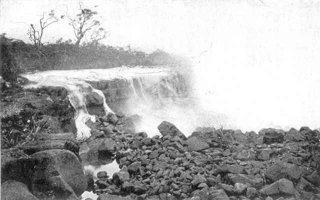 Lava stream, in Hawaiian Islands, flowing into the
sea. Note the "ropy" character of the half-frozen rock on the sides of
the nearest rivulet of the lava.