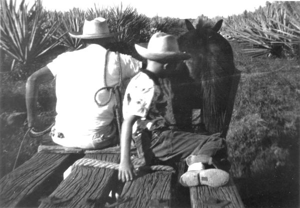 Riding an hacienda _plataforma_.  The author's son on the right, the hacienda driver on the left, the mule in front.